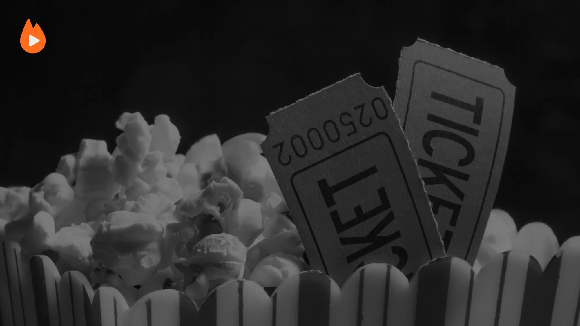 Two cinema tickets tucked into a striped box of popcorn, with the Ember TV flame.
